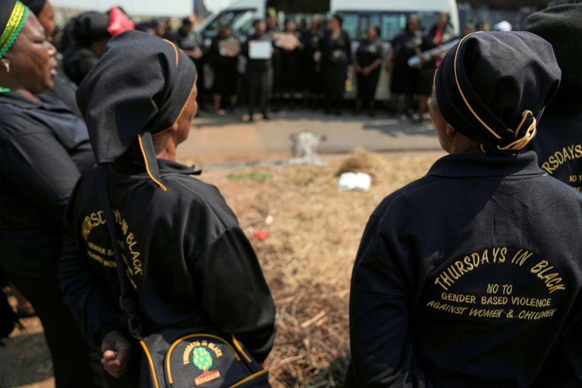 A women’s church group pay their respect at a scene of a discovery of the body of a 38-year-old woman last week while jogging, in Kempton Park, east of Johannesburg, South Africa.
