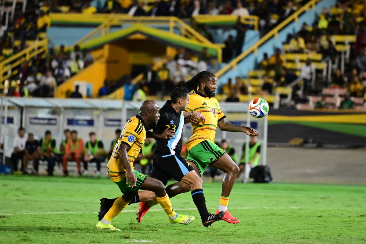 Reggae Boyz Javon East (left) and Kasey Palmer flank Guatemalan midielder Jorge Aparicio during a Concacaf Nations League encounter at the National Stadium on August 21.