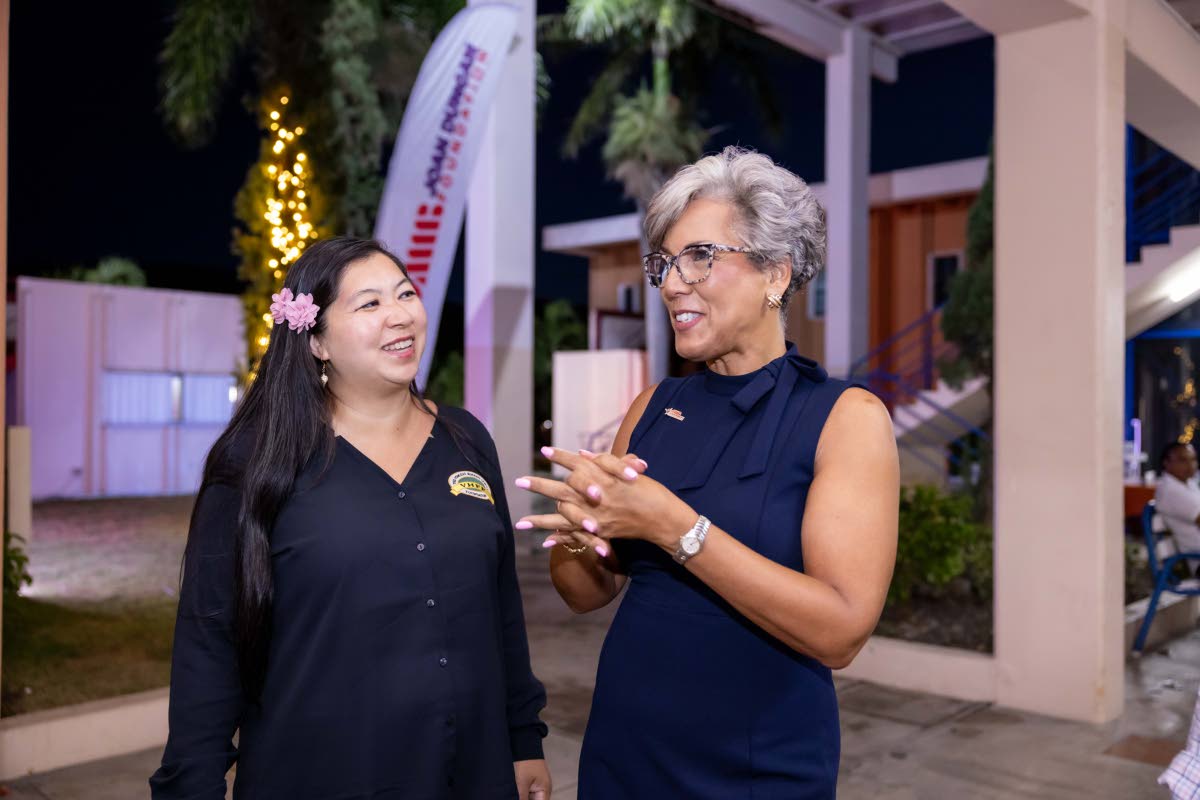 Kim Mair, CEO of the JMMB Joan Duncan Foundation (right), and Sabrina HoSang Jordan, CEO of Caribbean Food Delights and daughter of the late Vincent HoSang, engage in conversation at the launch of the Vincent HoSang UWI Venture Competition