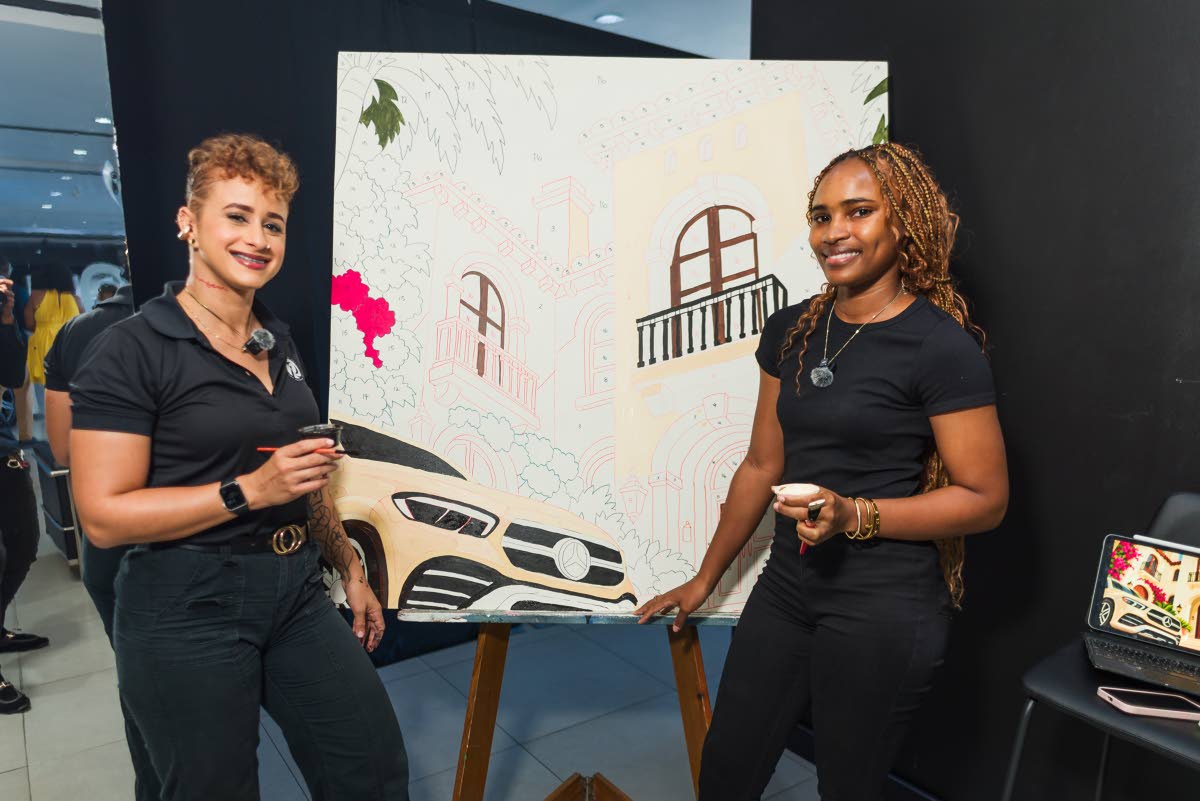 Simone Raquel (left), chief executive officer and designer of Simone Raquel Art, leads an interactive paint-by-number art installation, with Celine McKenzie assisting.