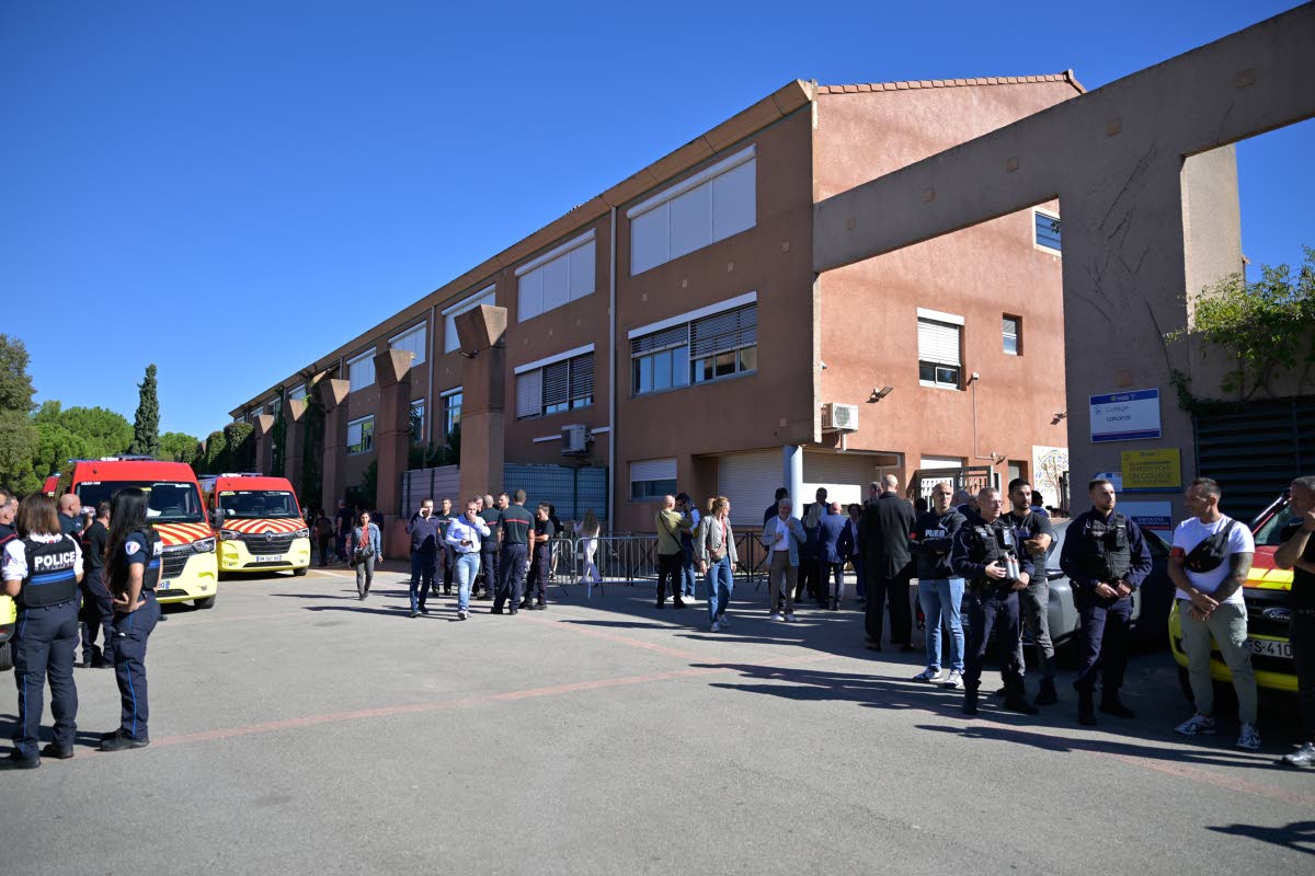 Police officers stand in front the Joseph Lakanal middle school after police have detained a 14-year-old pupil suspected in a rare school shooting, in Aubagne, France, Monday Oct. 12, 2026. (AP Photo/Philippe Magoni)