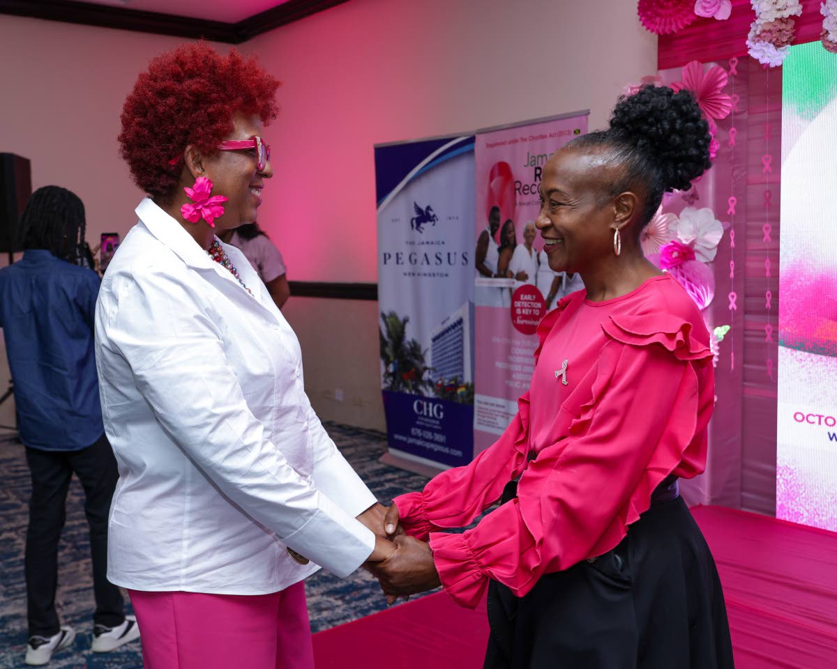 Jasinth Peddie (right) credits Jamaica Reach to Recovery with helping her navigate life after diagnosis. Pictured sharing a symbolic show of support with Peddie is Sandra Samuels, president of Jamaica Reach to Recovery.