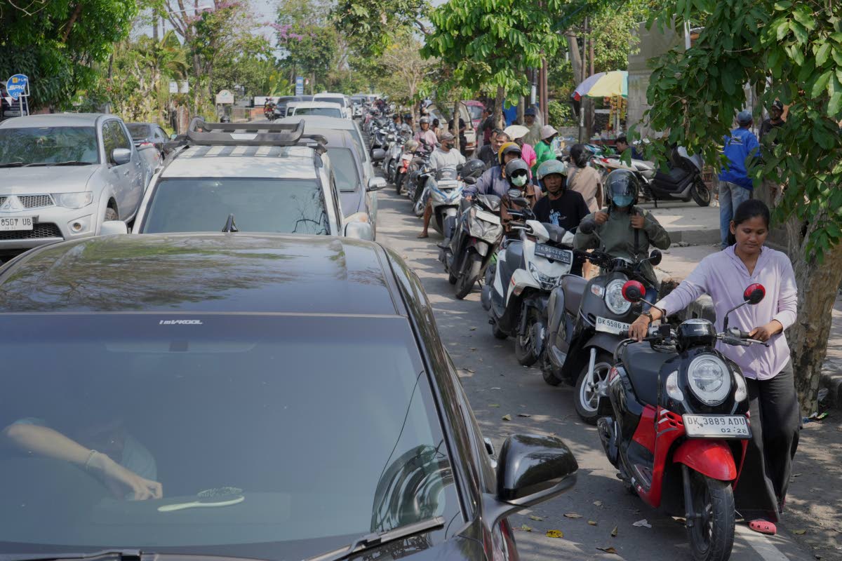 People queue at a gas station amid a fuel shortage in Denpasar, Bali, Indonesia, Wednesday.