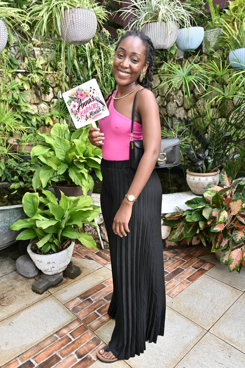 Dental Surgeon Shanice Cudjoe pairs a vibrant pink one-shoulder top with flowing black palazzo trousers, bringing effortless flair to an afternoon dedicated to music, generosity and hope.