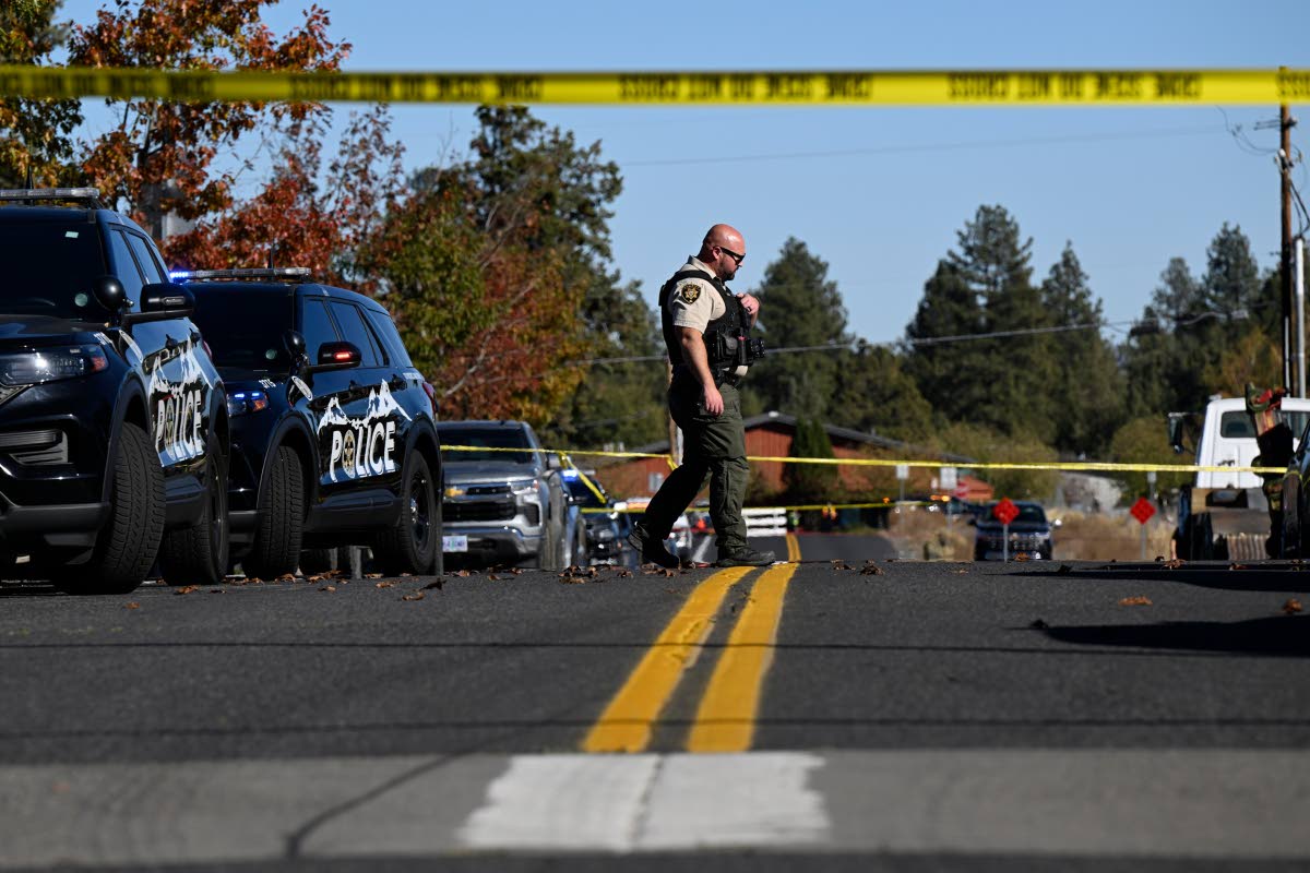 A sheriff's deputy walks outside Silver Rail Elementary school, where a shooting took place, on Thursday, Oct. 15, 2026 in Bend, Ore. (AP Photo/Joe Kline)