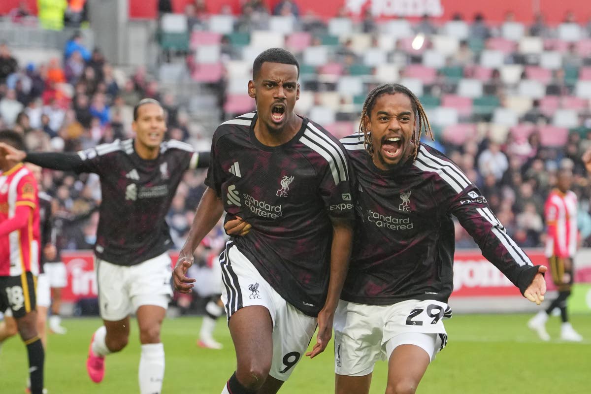 Liverpool's Alexander Isak, left, and Liverpool's Bradley Barcola celebrate after scoring during the English Premier League soccer match between Brentford and Liverpool in London, Saturday, Oct. 17, 2026. (AP Photo/Kin Cheung)