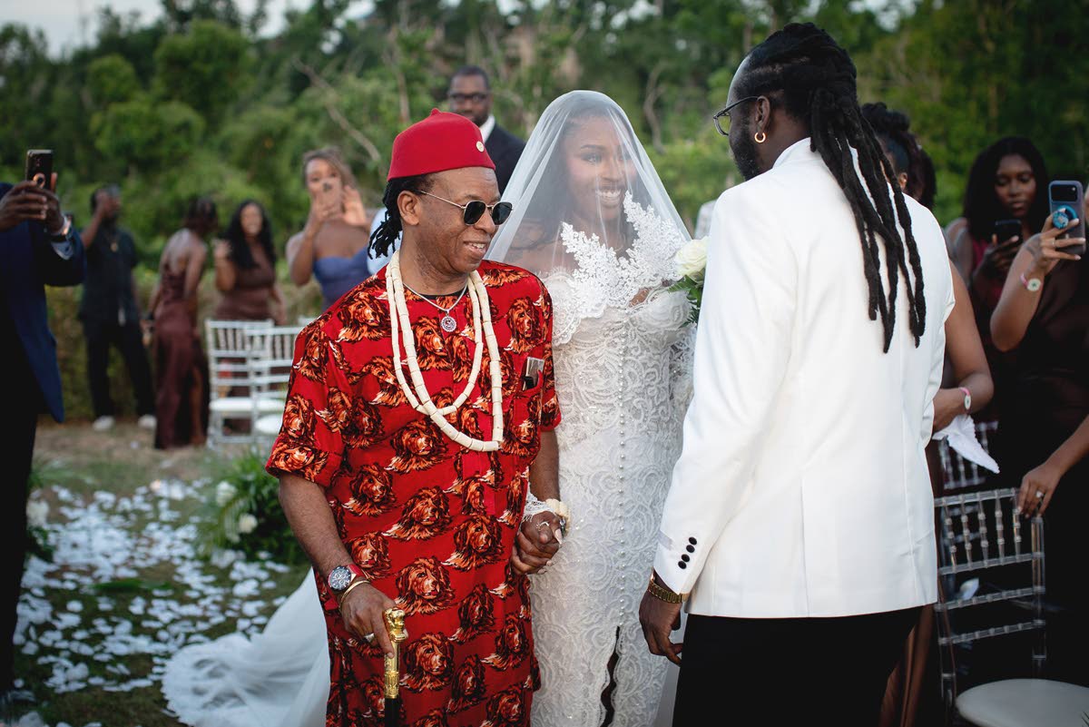 The bride’s father, Chief Ndubuisi Ogugua (Prince), presents her to her husband.