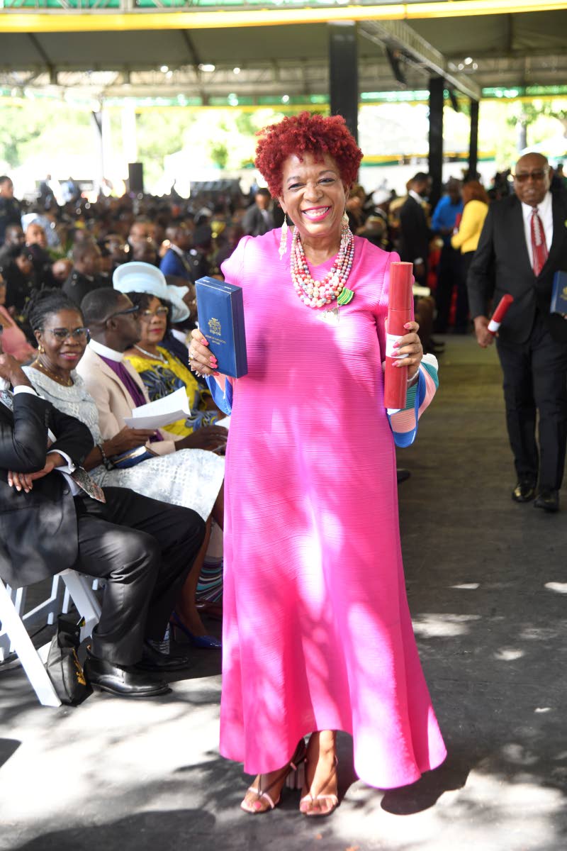 Staying true to pink for Breast Cancer Awareness Month, Sandra Samuels, president of Jamaica Reach to Recovery, receives the insignia of the Order of Distinction (Officer) in a look from Resortwear by Eroleen.