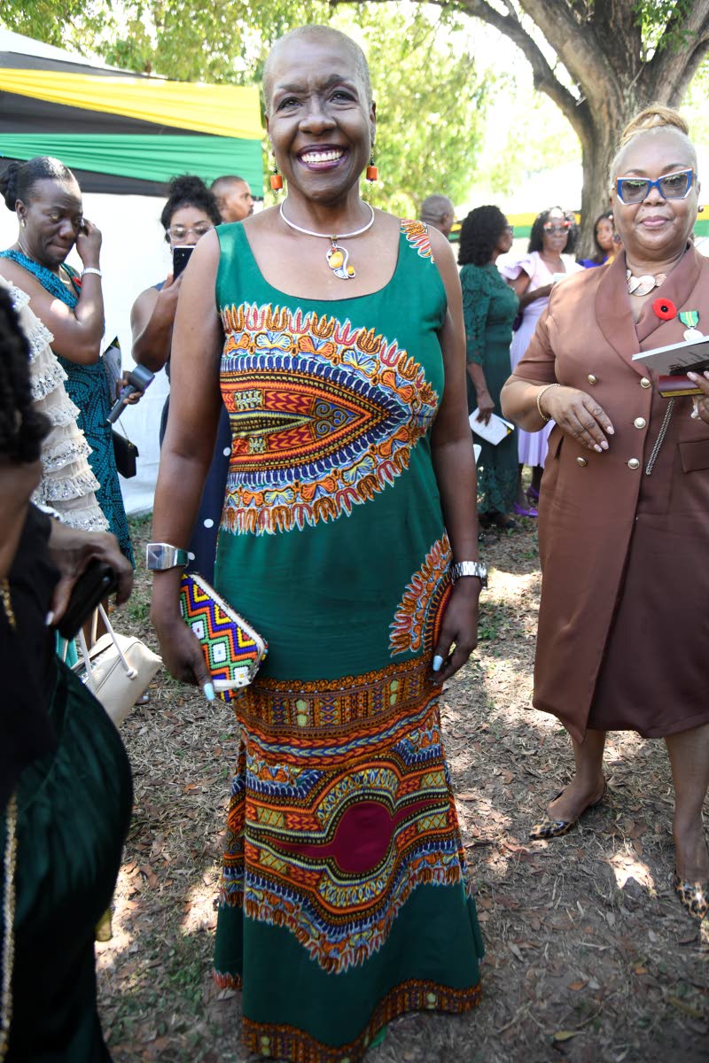 Public Defender Carolyn Reid Cameron taps a longtime wardrobe favourite, accessorising with a necklace from Xtras as she shows her support for the honourees.
