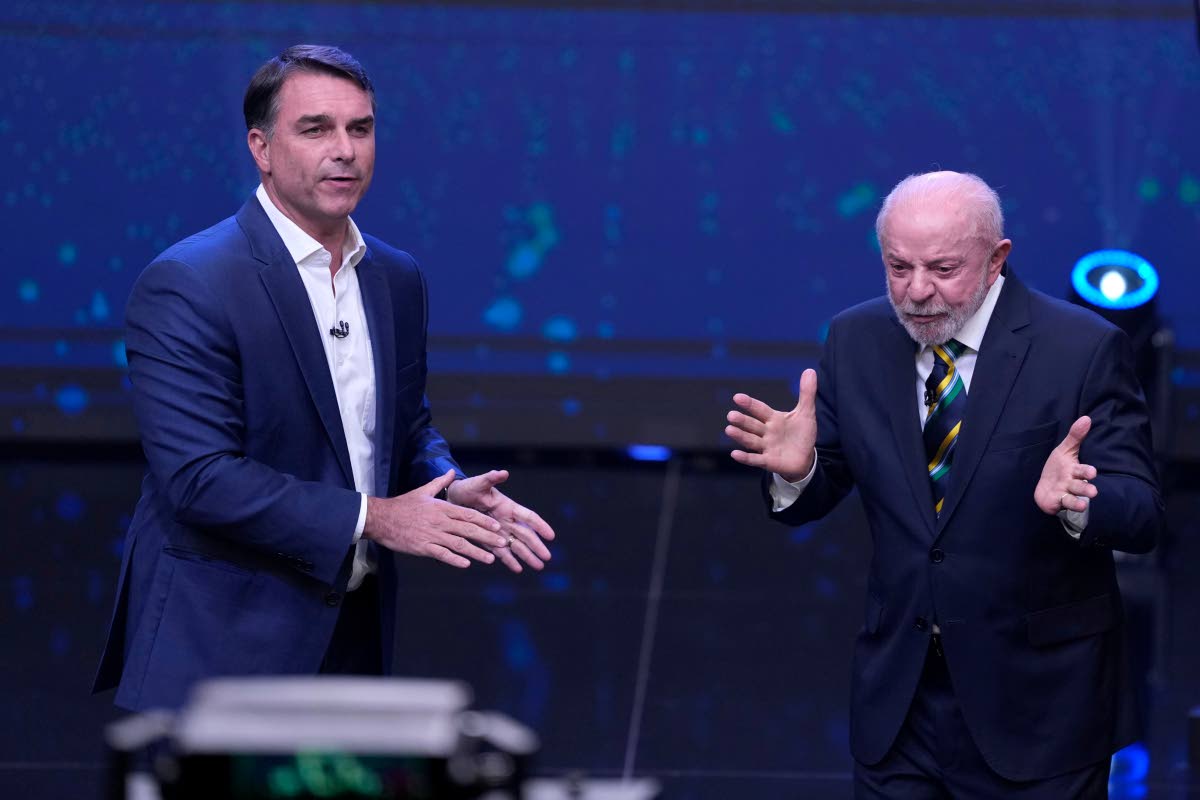 
Brazil President Luiz Inacio Lula da Silva, right, who is running for reelection, gestures as opposition presidential candidate Sen. Flavio Bolsonaro stands beside him during a televised presidential debate one week before the runoff election in Sao Paulo