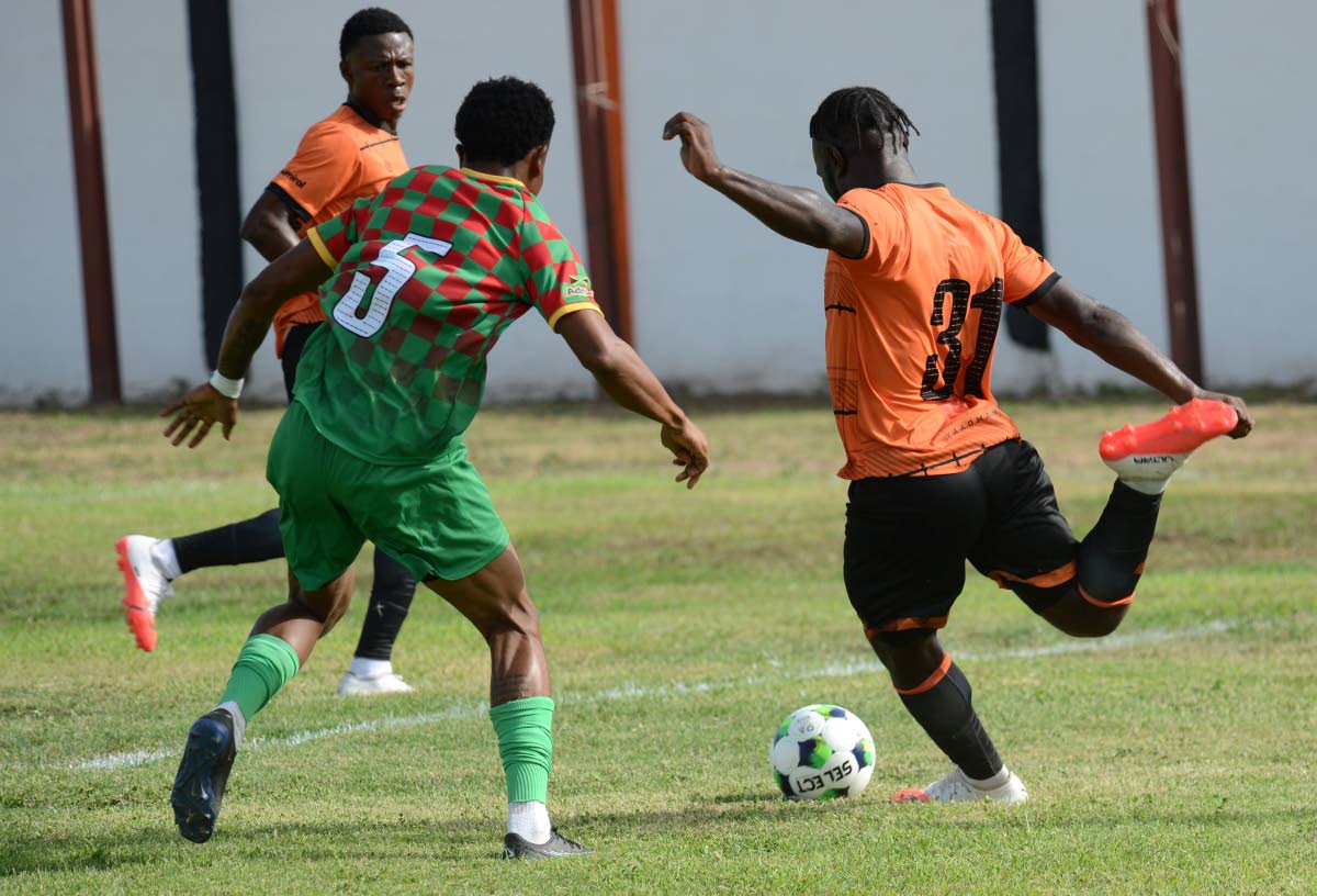 
Shawn Campbell (left) of Humble Lion moves in to block a shot from Alton Lewis of Tivoli Gardens during their Jamaica Premier League match at the Edward Seaga Sports Complex on September 13. 