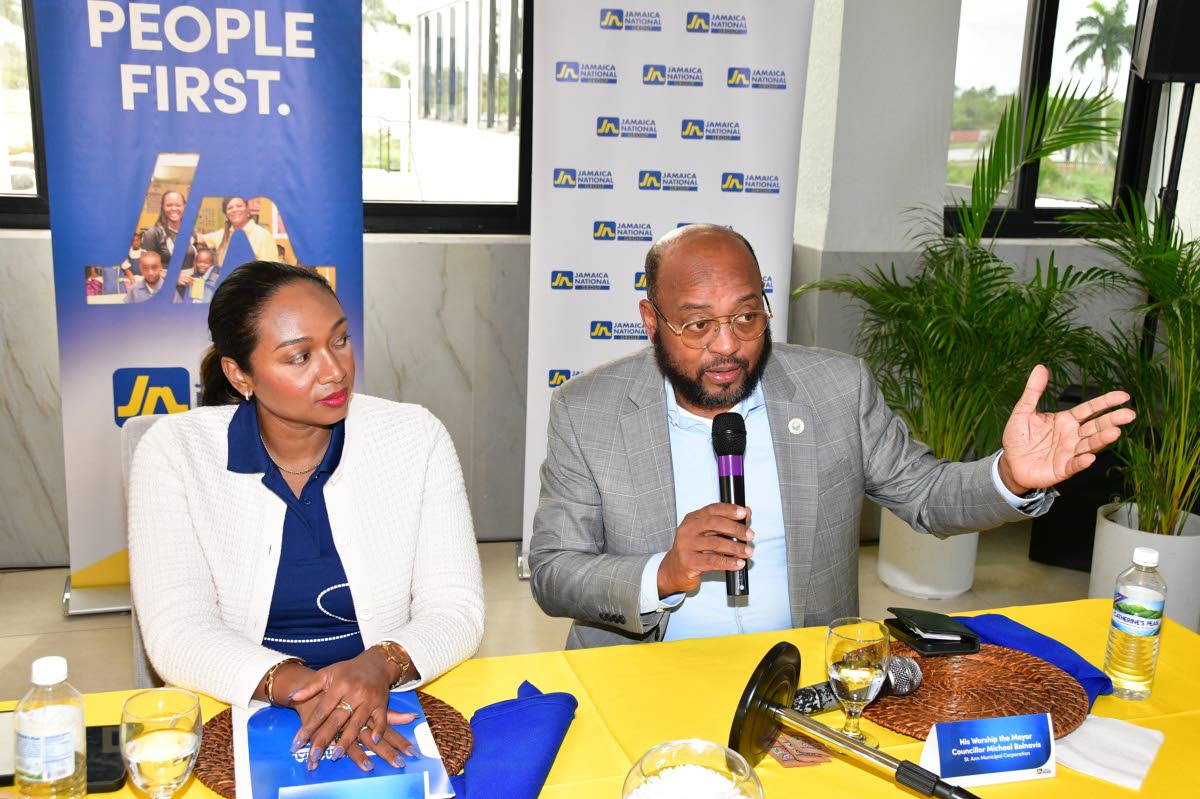 St Ann’s Bay Mayor, Michael Belnavis  makes a point about the developments taking place in the parish, while Luwanna Williams, managing director, JN Bank listens during a recent stakeholder breakfast meeting organised and hosted by The Jamaica National G
