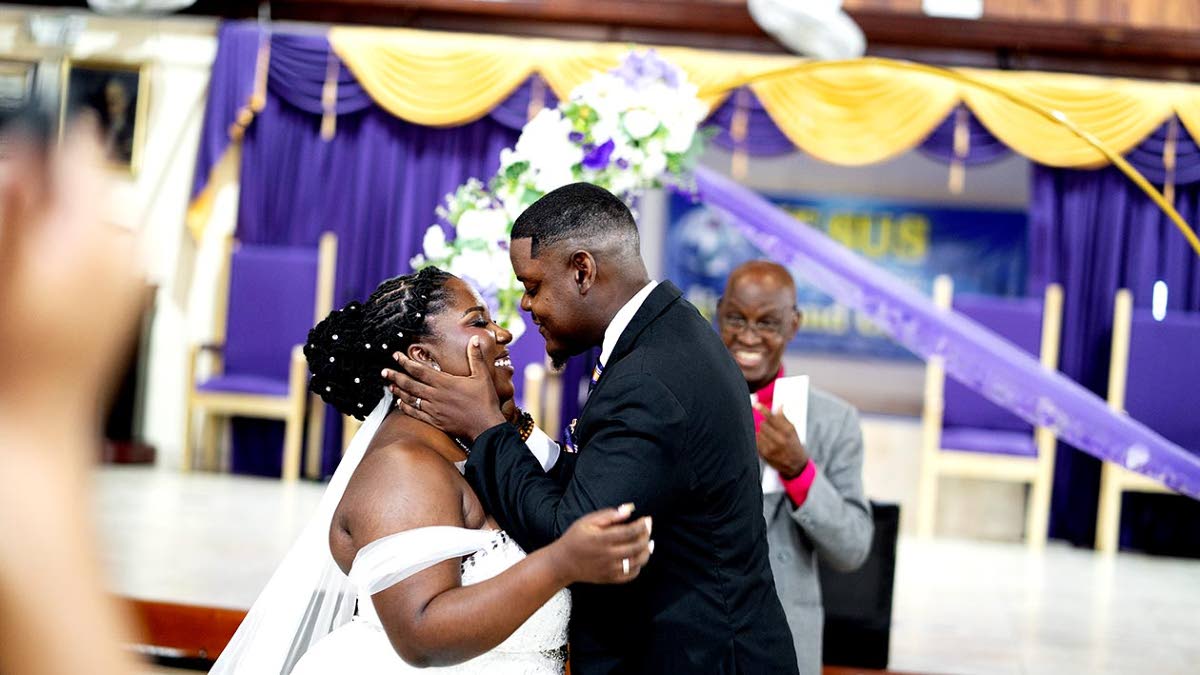 Akeeve leans in to kiss his bride, Throyann, after the officiant declared, “You may now kiss the bride”. 