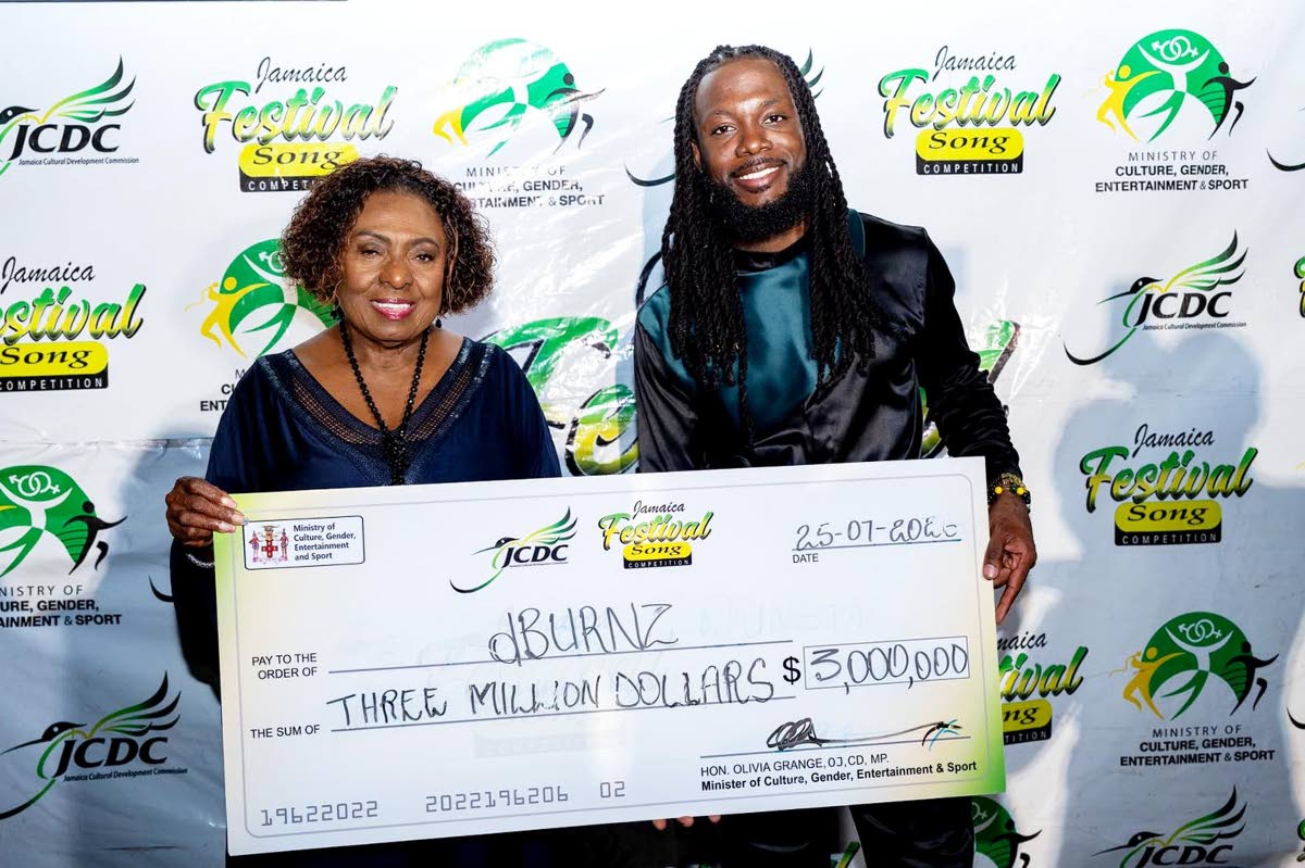 The 2026 Festival Song Competition winner, dBurnz, is presented with one of his prizes by Minister of Culture, Gender, Entertainment and Sport, Olivia Grange.