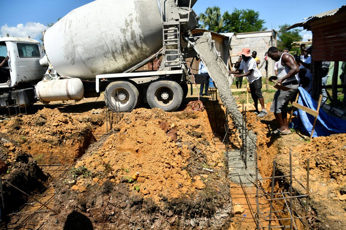 Concrete being poured as a part of a container home construction at Wanstead Road in St Elizabeth. 
