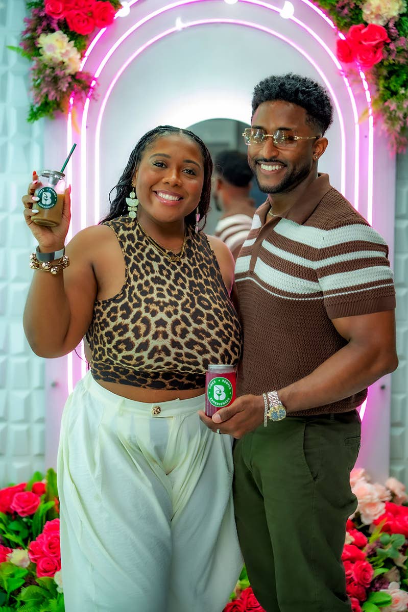 Candice Constantine smiles while showing off her caramel iced coffee. Her friend, Aaron Linton, opted for the dragonfruit lemonade.