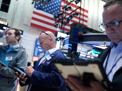 Traders work on the floor at the New York Stock Exchange in New York, Monday, July 6, 2026. 