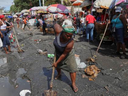 Vendors clean a street before starting to sell their goods in the Petion-ville neighbourhood of Port-au-Prince, Haiti.