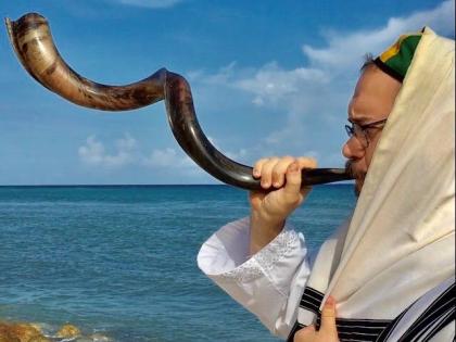 Jamaica’s rabbi sounds the ram horn known as the shofar.