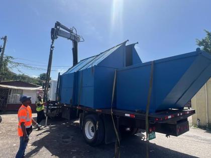 Workmen placing the skips strategically for easy access by business owners, locals and others in the Negril bus park