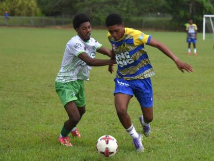 Maliek Headed of Rusea's High tries to shake from Frome Technical High's Jevani Plummer (left) during their ISSA daCosta Cup Zone B match at the Collin Miller Sports Complex in Lucea, Hanover on Tuesday, September 16. The match was called off owing to ligh