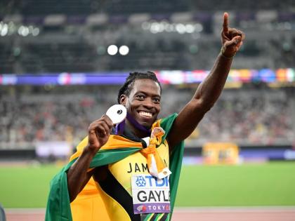Tajay Gayle shows off the silver medal he mined from the World Athletics Championships long jump yesterday with his leap of 8.34 metres.  