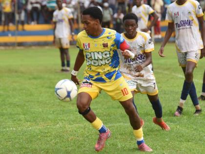 St Elizabeth Technical High School (STETHS) skipper, Deandre Barnett (left), moves away from Munro College’s Silence Manyaka during their ISSA daCosta Cup Zone E game at the STETHS Sports Complex in September.