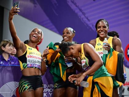 Shelly-Ann Fraser-Prycee (left) celerates her 17th World Championship medal, a silver in the women's 4x100 metres, by taking a selfie with her teammates from left: Tina Clayton, Tia Clayton, and Jonielle Smih.