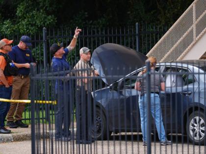A law enforcement agents search a vehicle near the scene of a shooting at a US Immigration and Customs Enforcement office in Dallas on Wednesday, September 24, 2025. (AP Photo/Julio Cortez)