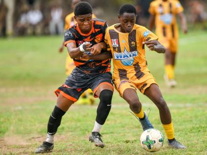 Ryan-Oniel Francis (left) of Tivoli High and  Marlon Anderson of Haile Selassie High battle for possession during yesterday’s ISSA Manning Cup match at Tivoli. The game ended in a 2-2 draw.