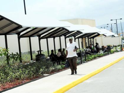 Visa applicants sit outside the United States Embassy in St Andrew.