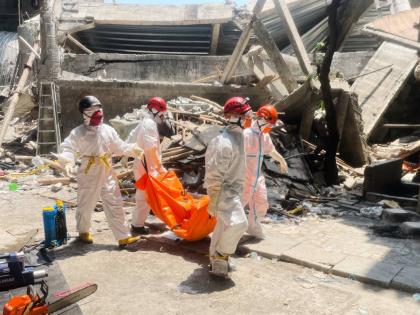 Rescuers carry the body of a victim of a collapsed building at an Islamic boarding school in Sidoarjo, East Java, Indonesia yesterday.