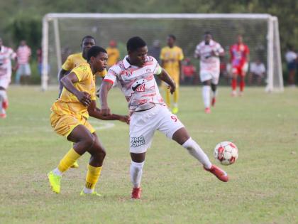 Glenmuir High’s Orane Watson (right) and  Garvey Maceo High’s  Ajani Johnson battle for the ball during their  top-of-the-table clash at Garvey Maceo on Tuesday, September 30. Glenmuir won 4-0. 