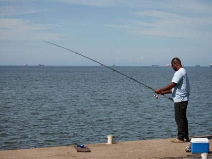A man fishes in Cocorite, Trinidad and Tobago.