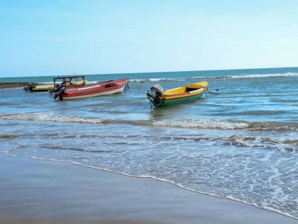 Fishing boats bobbing on the sea on the Jamaican coastline.