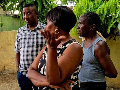 Kingston Mayor Andrew Swaby (left) with Trafalgar Park flood victim Nadine Thompson (centre) during a visit on October 7, 2025. 