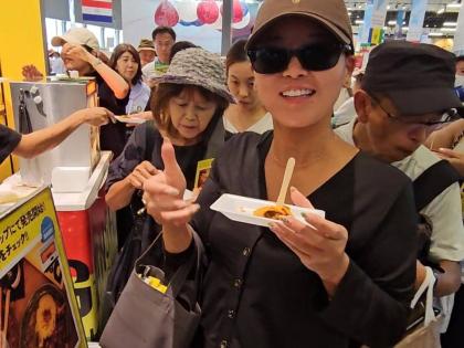 A visitor to the Jamaica Pavilion at Expo 2025 Osaka, Kansai, Japan, gives the beef patty a thumbs-up after taking a bite at the sampling event, held at the Jamaica Pavilion on October 7. The patties were presented by Gangalee Kitchen, a Jamaican Restauran