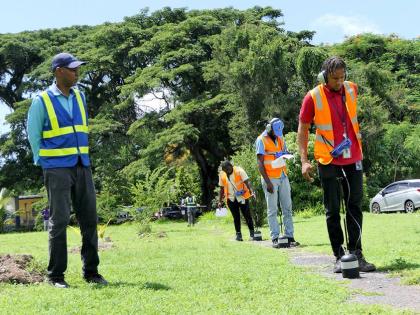 Team Leader Ian Manderson (left) pays careful attention to the work being done by the students – (front to back) Givaughn Jobson, Demar Lewis and Nichol Coleman – during the Leak Detection practical training session recently.