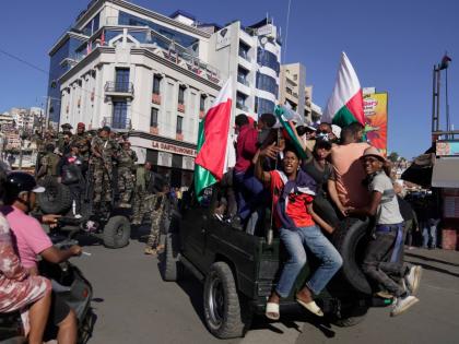 Troops loyal to CAPSAT military unit commander Col. Michael Randrianirina make their way to the presidency to announce that the armed forces are taking control of the country in Antananarivo, Madagascar, Tuesday, October14, 2025. (AP Photo/ Brian Inganga)