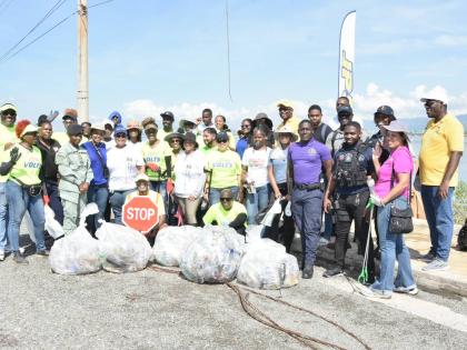 Representatives from JPS, National Environment and Planning Agency (NEPA), Independent Cadet Unit, Courtyard Marriott and members of the Jamaica Constabulary Force following the beach cleanup activity at Sturridge Park mangrove site in Kingston 