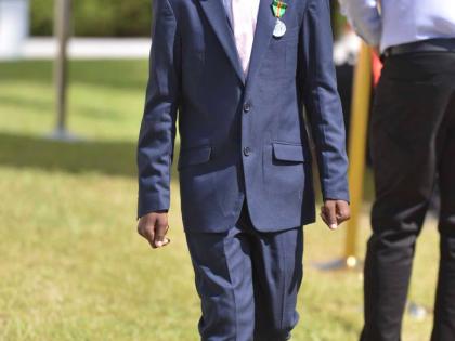 Adrian ‘Ajani’ Ellis after being conferred with the Badge of Honour for Gallantry during the National Honours and Awards Ceremony held on the lawns of King’s House in St Andrew yesterday.