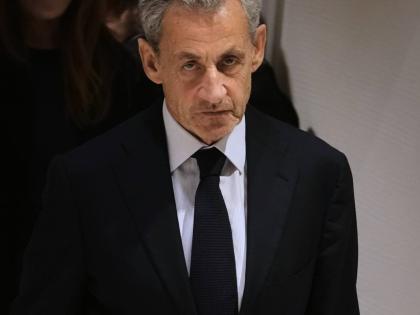 Former French President Nicolas Sarkozy leaves after a Paris court sentenced him to 5 years after finding him guilty of criminal conspiracy in an alleged scheme to finance his 2007 campaign with funds from Libya.