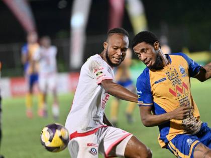 Forward Rohan Brown (right) of Harbour View and Portmore United’s defender Stephen Young battle for the ball during a Jamaica Premier League match in October.