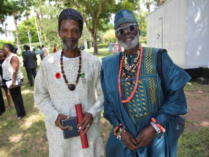 Tim Abayomi Badejo (right) shared that he simply had to be in Jamaica to support his friend Hilbert ‘Berty’ Grant, who received a Badge of Honour for Meritorious Service at the National Honours and Awards ceremony on National Heroes Day.
