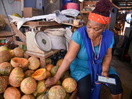 Munchun, a market vendor, speaks with The Gleaner in Coronation Market in downtown Kingston yesterday.