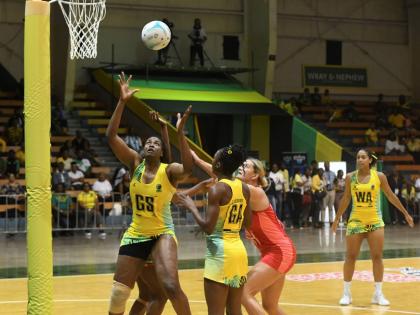 Sunshine Girl Romelda Aiken-George (left) gets into position to grab a rebound during a netball match in the Horizon Netball Series against the England Roses at the National Indoor Sports Centre on November 26, 2024. Looking on at second right is Shanice B