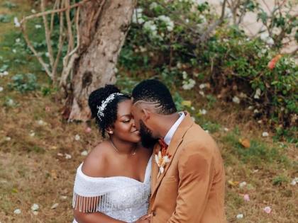 Basking in unforgettable nuptial bliss, the married couple lean in to share a kiss.