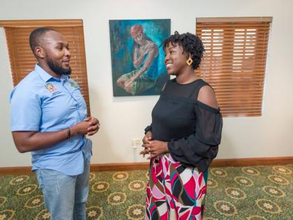 Olivia Shaw-Lovell (right), founder of Men and Women of Destiny Global Limited, and Akeem Bender, project manager – social intervention, Ministry of National Security, discuss expanding mentorship opportunities for at-risk youth under the Citizen Securit