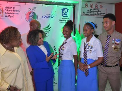 Minister of Culture, Gender, Entertainment and Sport Olivia Grange (left) and Minister of Education, Skills, Youth and Information Senator Dr Dana Morris Dixon interact with Ardenne High School students (from third left) Arhiyanna Kentish, Rihanna Henry an