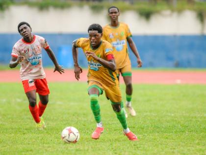St Jago High School’s Jordan Taylor (right) dribbles away from Mona High School’s Franklyn Mitcham during their ISSA/WATA Manning Cup encounter at the Jamaica College Ashenheim Stadium on October 22.